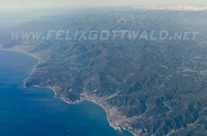 Air view on port city of Savona with the Sea Alps in the background