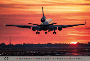A KLM MD-11 is touching down during sunrise at Amsterdam Schiphol Airport. 