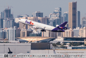 August motive of the MD-11 Calendar 2015 showing a Fedex MD-11 rocketing out of Dubai with the skyline of Sharjah in the background.