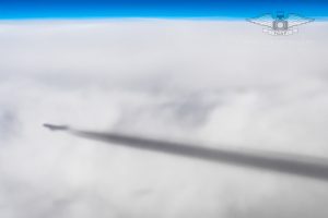 Contrail of a MD-11 over the clouds