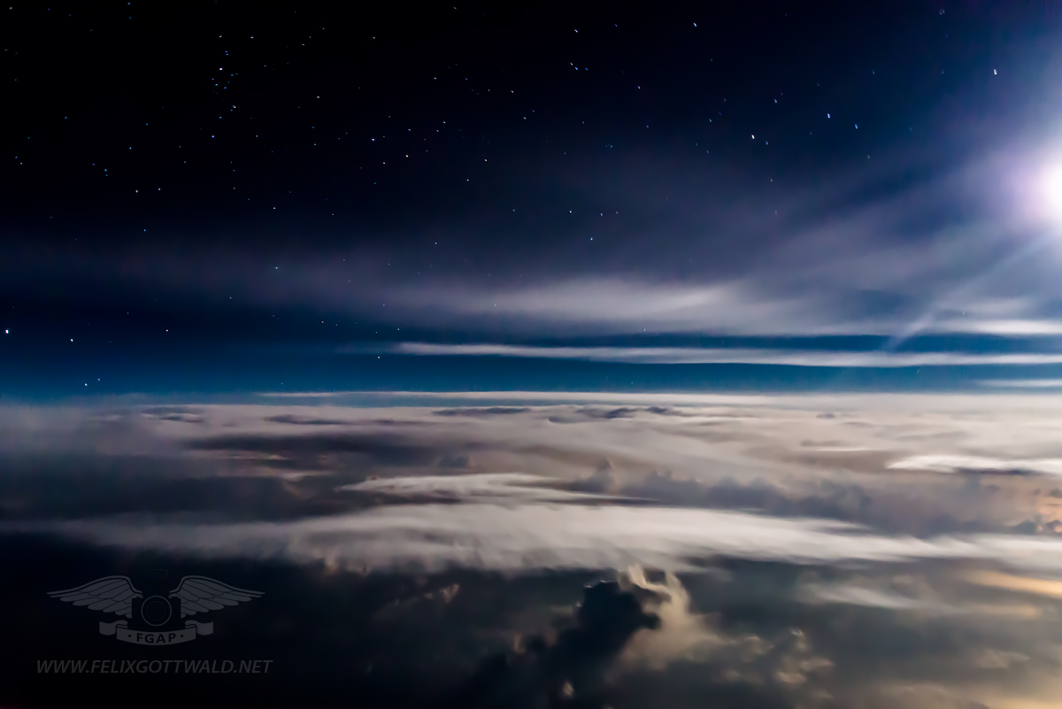 Flying above the clouds during a moonlit night 01